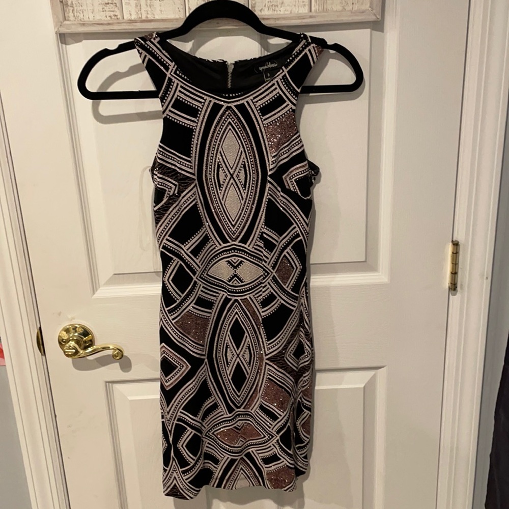Fitted mini dress, worn once. Black and white design with rose gold.